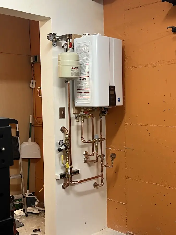 Plumbing technician inspecting water heater connections in Palatka
